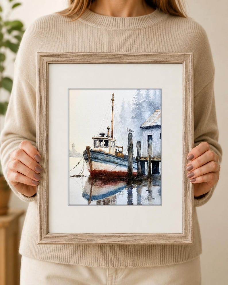 May include: A framed watercolor painting depicting a blue and white fishing boat moored at a wooden dock. The scene features a small structure on the pier, a seagull perched on a post, and a misty forest background with a reflection in the water.