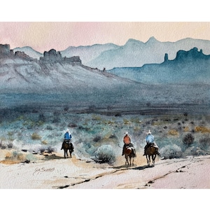 May include: Watercolour painting depicting three cowboys on horseback, traversing a dirt track. The backdrop showcases a mountain range in varying shades of blue and a pink and beige sky. The artist's signature is visible.