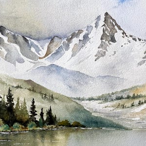 May include: A watercolor painting depicting a snow-capped mountain range rising above a calm lake. The foreground features dark green pine trees along the shoreline, while the peaks are rendered in shades of white, gray, and soft blue tones.