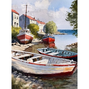 May include: Watercolor painting of a coastal scene with several boats beached near buildings with red roofs. The boats are painted in red, white, and blue, with a calm sea in the background under a blue sky.
