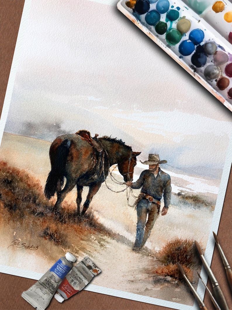 May include: Watercolor painting of a cowboy leading a saddled horse. The cowboy wears a hat, blue shirt, and jeans. The horse is brown. Paint tubes and brushes are in the foreground. A palette of watercolors is in the upper right corner. The artist's signature is in the lower left corner.