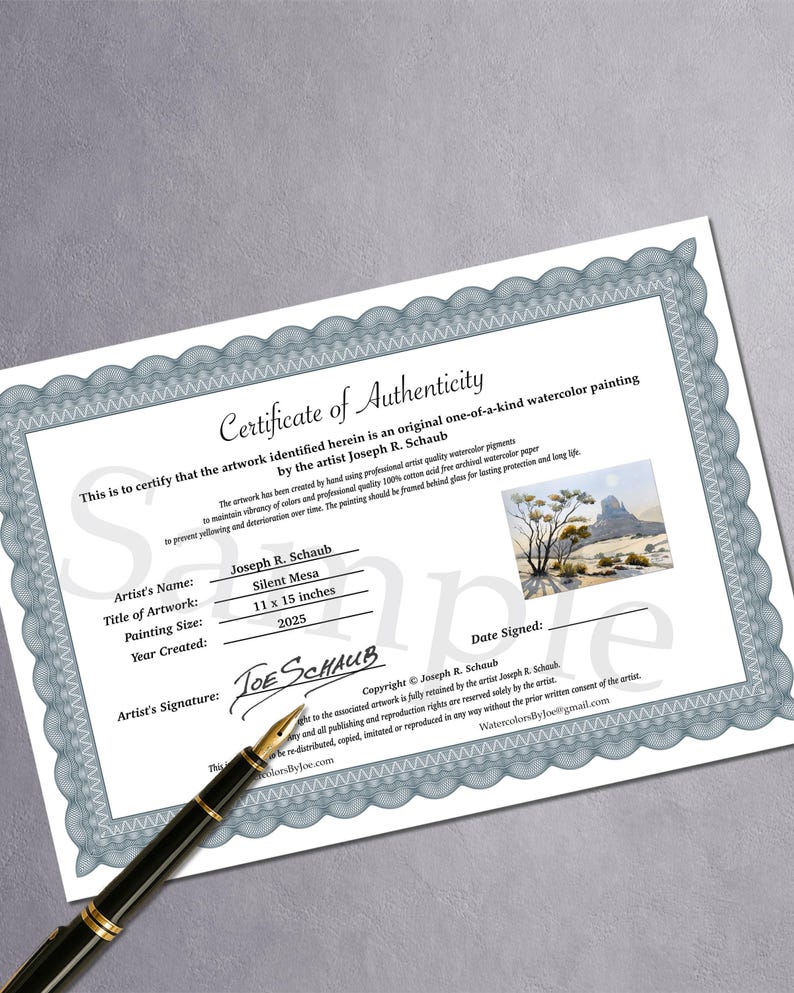 May include: A certificate of authenticity for a watercolor painting, featuring the artist's name, artwork title "Silent Mesa", and size 11 x 15 inches. The document includes the artist's signature and copyright information, with a pen resting on the certificate.