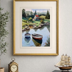 May include: Watercolor painting of a serene lake scene with two small boats. The artwork features a house with a red roof nestled among green trees and a winding path. The painting is framed in a gold frame.