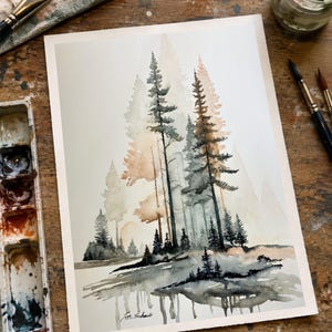 May include: A watercolor painting on paper depicting a forest scene with tall pine trees in shades of grey, black, and soft orange. The trees are reflected in a body of water at the bottom. The artist's signature, Joe Schaub, is visible in the corner.