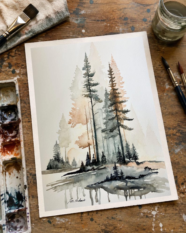 May include: A watercolor painting on paper depicting a forest scene with tall pine trees in shades of grey, black, and soft orange. The trees are reflected in a body of water at the bottom. The artist's signature, Joe Schaub, is visible in the corner.