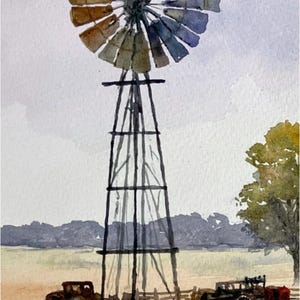 May include: Watercolor painting of a rural landscape featuring a windmill with a multi-colored fan. The windmill's dark frame stands tall against a cloudy sky. An old truck and a small fence are in the foreground, with a field and trees in the background.