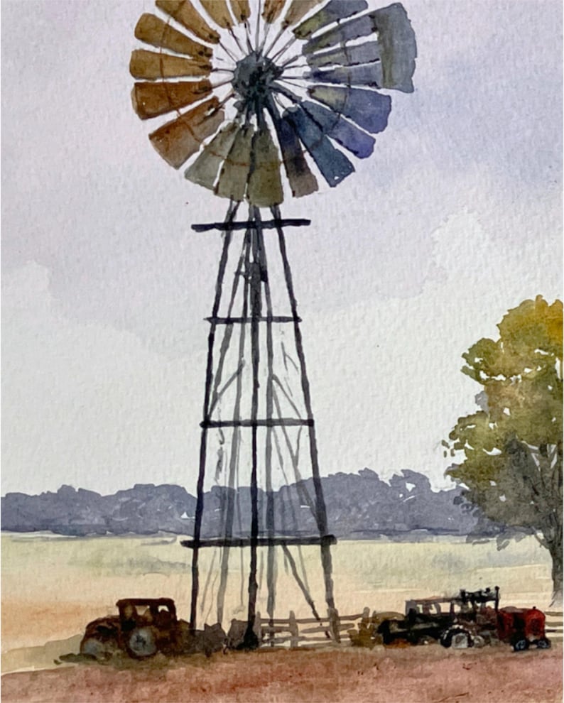 May include: Watercolor painting of a rural landscape featuring a windmill with a multi-colored fan. The windmill's dark frame stands tall against a cloudy sky. An old truck and a small fence are in the foreground, with a field and trees in the background.