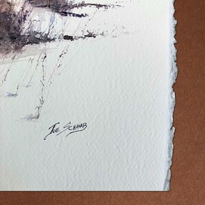 May include: A watercolour landscape painting depicting a snowy field and trees, with shades of brown, purple, and white. The artist's signature, "Joe Schaub," is in the lower left. The paper has a deckled edge, giving it a textured appearance.
