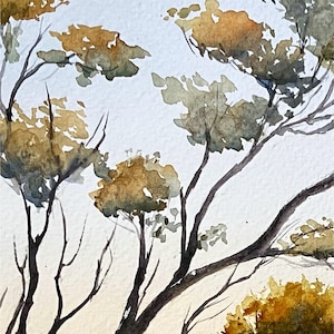 May include: Watercolor painting of tree branches with olive green and golden leaves against a light blue and cream background. The artwork depicts a natural landscape with a soft, artistic style.