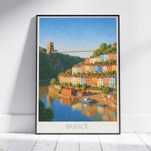 Peut inclure: Impression encadrée de Bristol, représentant des maisons colorées en terrasses, un pont suspendu et une rivière. Le style est celui d'une affiche de voyage vintage, avec le nom de la ville en bas.