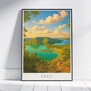 May include: Framed landscape art print featuring a scenic view of a lake and surrounding hills under a blue sky with fluffy clouds. The artwork has a vibrant color palette of greens, blues, and yellows. The word "KRKA" is printed at the bottom.