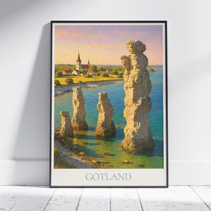 May include: A framed print depicting a coastal scene with large rock stacks in the foreground. A church and village are in the background under a colorful sky. The word "GOTLAND" is printed at the bottom.