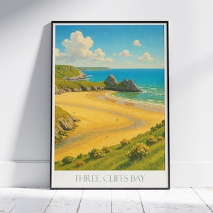 May include: A framed print of Three Cliffs Bay, showcasing a coastal landscape. The image displays a sandy beach, turquoise sea, and green cliffs under a blue sky with white clouds. The text "THREE CLIFFS BAY" is at the bottom of the print.