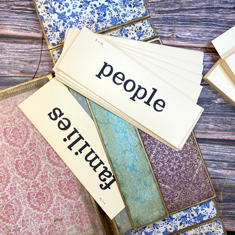 May include: Two cream-colored index cards with black text. The top card reads "people" and the bottom card reads "families".