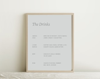 May include: A framed print with a white background and black text listing different drink options, including Umeshu Sour, Lychee Martini, Beer, and Wine. The text reads "The Drinks" at the top.