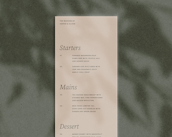 May include: A wedding menu with a beige background and black text. The menu lists the starters, mains, and dessert options for the wedding of Harper & Oliver. The starters include foraged mushroom soup, caramelized rice cakes, and the mains include ter-smoked duck breast and wok-fried lobster tail. The dessert is mango sorbet with grapefruit.