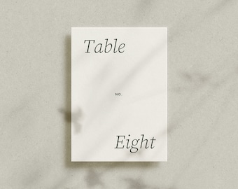 May include: White table number card with the text "Table No. Eight" in black cursive font.