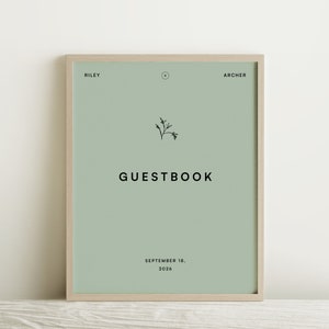 Puede incluir: Un cartel enmarcado verde claro con el texto "GUESTBOOK" en negro. El cartel también incluye los nombres "RILEY" y "ARCHER" en negro y la fecha "SEPTEMBER 18, 2026" en negro.