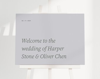 May include: A white easel with a light grey sign that reads "Welcome to the wedding of Harper Stone & Oliver Chen" and the date "08.17.2024".