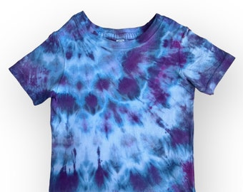 May include: A blue and purple tie-dye t-shirt with short sleeves.
