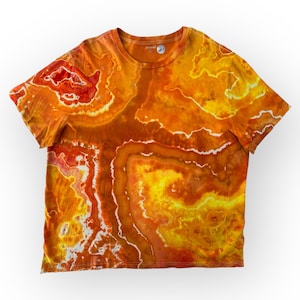 May include: Orange, yellow, and red tie-dye t-shirt. The short-sleeved shirt has a crew neck and a marbled pattern with white vein-like lines. The Old Navy logo is visible on the neckline.