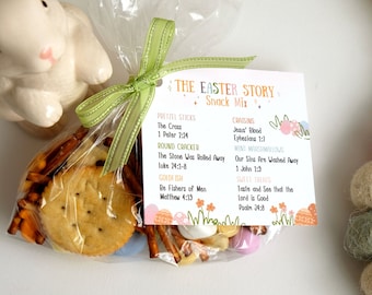 May include: A clear plastic bag filled with pretzels, crackers, goldfish crackers, and candy. A tag attached to the bag reads "The Easter Story Snack Mix" and lists bible verses and snack items related to the Easter story.