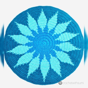 May include: A crocheted round rug with a blue and turquoise starburst design.