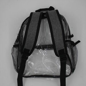 May include: A gray clear backpack with black straps and mesh side pockets. The backpack is designed to be see-through.