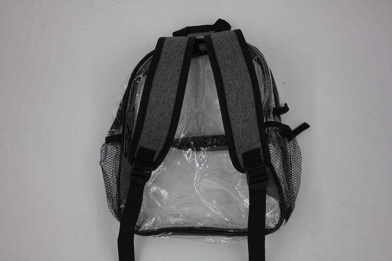 May include: A gray clear backpack with black straps and mesh side pockets. The backpack is designed to be see-through.