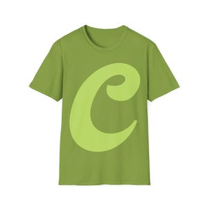 May include: A green t-shirt with a large, light green stylized letter "C" on the front.
