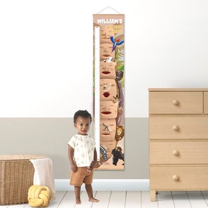 May include: A brown and tan personalized growth chart with a jungle theme. The chart features a variety of animals, including a lion, zebra, monkey, and sloth. The chart is labeled "William's Height Chart".