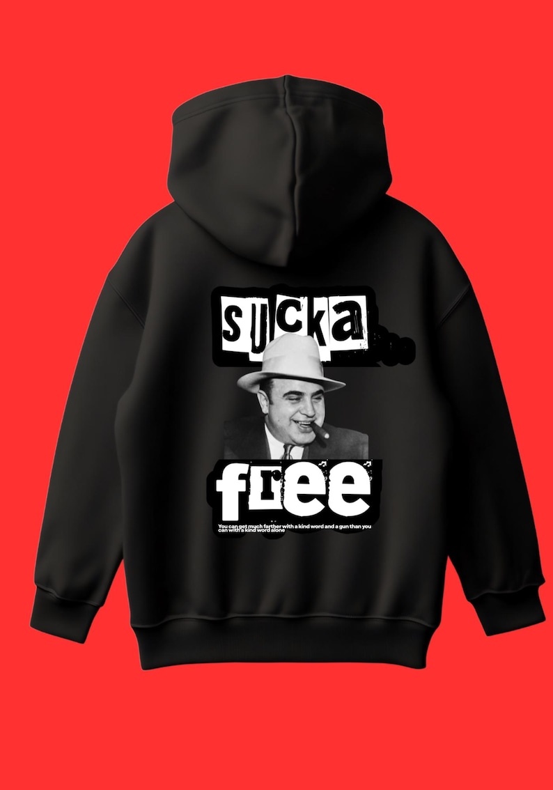 May include: Black hoodie with a graphic design featuring a black and white image of a man in a fedora smoking a cigar. The text "SUCKA FREE" is above and below the image, with additional text at the bottom.