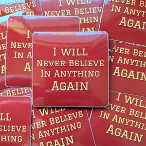 May include: Red square stickers with the text "I will never believe in anything again" in yellow letters.