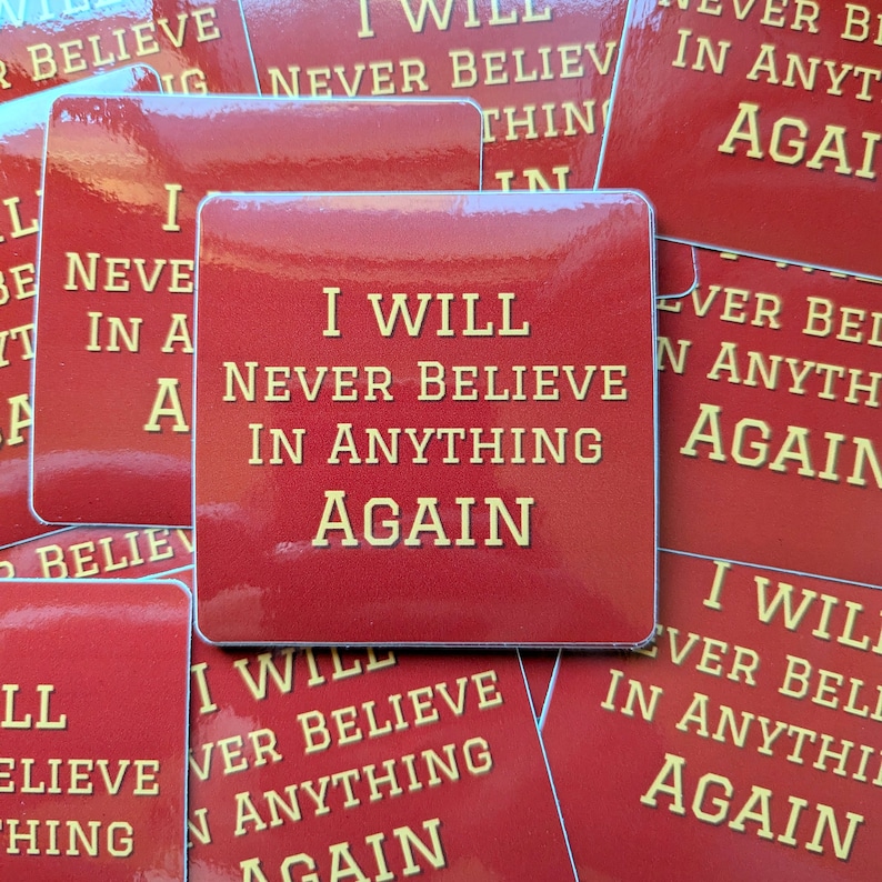 May include: Red square stickers with the text "I will never believe in anything again" in yellow letters.