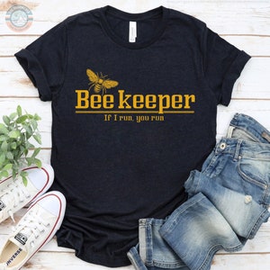 May include: A black t-shirt with a yellow bee graphic and the text "Bee Keeper If I run, you run".
