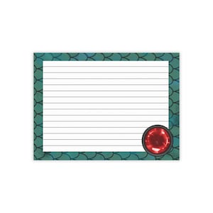 May include: A rectangular notepad featuring a white centre with horizontal black lines for writing. The border displays a teal and dark green fish scale pattern. A circular, glossy red gemstone graphic is positioned in the bottom right corner.