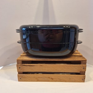 May include: A white ceramic mug with a black handle and the text "But First, Coffee" in a black, handwritten-style font. The mug is on a white surface.