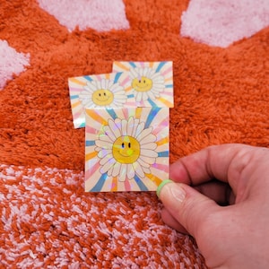 Smiley Face Daisy Holographic Sticker - Cheerful and Vibrant Decal for Adding Joyful Flair