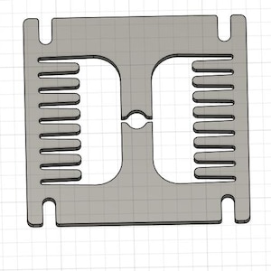 May include: A gray metal comb with two rows of teeth. The comb has a small hole in the center.