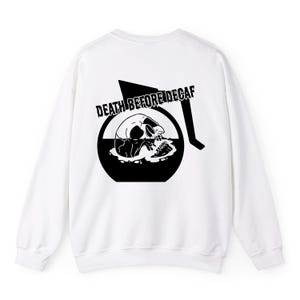 May include: White sweatshirt with a black graphic of a skull inside a coffee pot with the text "DEATH BEFORE DECAF" printed on the back.