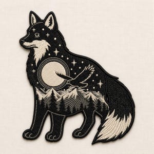 May include: An embroidered patch in the shape of a standing fox. The black fox features a white chest, tail tip, and face accents. Inside the fox silhouette is a scene of a full moon, a flying bird, mountain peaks, and a forest under stars.