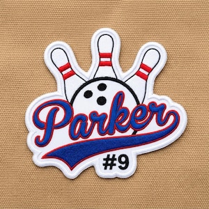 May include: An embroidered patch featuring three white bowling pins with red stripes, a white bowling ball with black finger holes, and the blue script text Parker underlined with a blue swoosh, with the black text #9 positioned below the design.