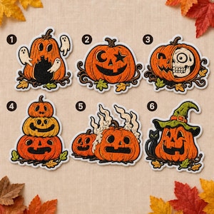 May include: Six embroidered iron-on patches featuring Halloween pumpkin designs. Patch 1 shows a pumpkin with ghosts, 2 a star-eyed pumpkin, 3 a skull-faced pumpkin, 4 a stack of three pumpkins, 5 pumpkins with smoke, and 6 a pumpkin wearing a witch hat.