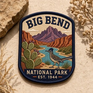 May include: An embroidered patch featuring a landscape of Big Bend National Park. The design includes a roadrunner, prickly pear cactus, a winding blue river, and purple mountains under a beige sky. Text reads BIG BEND NATIONAL PARK EST. 1944.