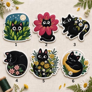 May include: Six embroidered patches featuring black cats in various scenes: a cat in green foliage under a moon, a cat inside a pink flower, a cat with white daisies, a curled cat with pink flowers, a cat among yellow flowers, and a cat on a moon.
