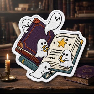 May include: An embroidered patch featuring four white ghosts interacting with open books. One ghost emerges from a purple book, while others hold small yellow crescent moons. The open pages display a yellow star and black line illustrations.