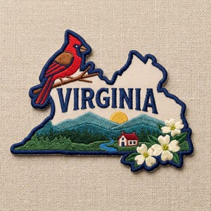 May include: An embroidered patch shaped like the state of Virginia, featuring a red cardinal on a branch, the text VIRGINIA in blue, a mountain landscape with a sun, a small house, a blue stream, and white dogwood flowers with green leaves.