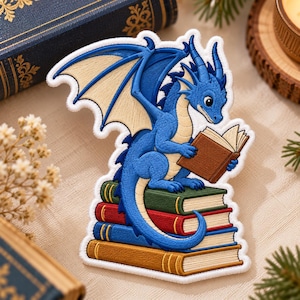 May include: An embroidered patch featuring a blue dragon with cream-colored wings, sitting atop a stack of four books while holding an open brown book. The dragon has horns and a long tail, and the books are colored green, red, blue, and tan.