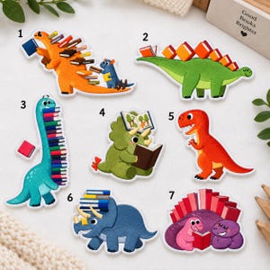 May include: Seven embroidered patches featuring colorful dinosaurs interacting with books. Designs include an orange dinosaur with books on its back, a green stegosaurus with books, a blue long-necked dinosaur with a stack of books, and others.