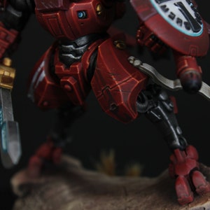 Commander Farsight Warhammer 40k miniature, professionally hand painted in Farsight Enclaves red and white. T'au Empire battlesuit commander, Elite tier display-quality commission painting, fully built, based and varnished.